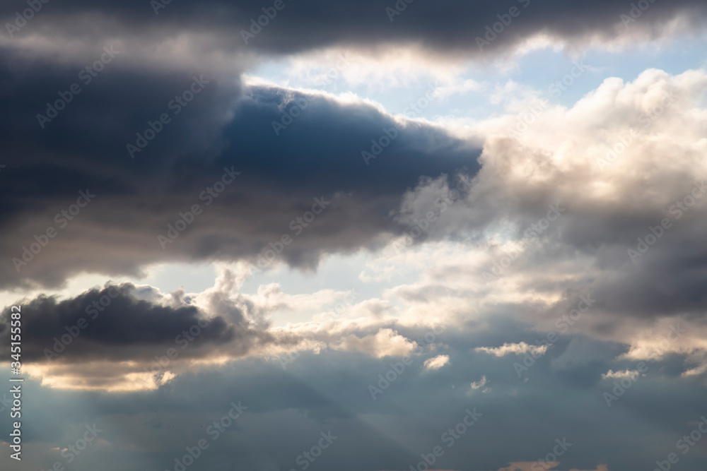 Dark clouds in the blue sky before a thunderstorm. Abstract contrasting background. Dark clouds in the blue sky before a thunderstorm. Abstract contrasting background.