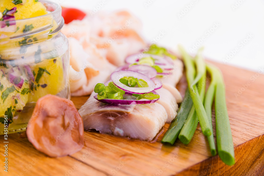 Russian traditional snack on a wooden board on a white background Russian traditional snack on a wooden board on a white background