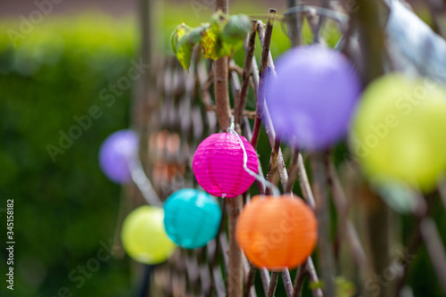 bunte Lampions am Gartenzaun