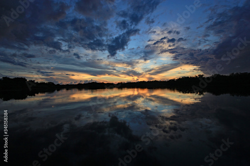 Colorful sunset and reflection on Nine Mile Pond after storm in Everglades National Park  Florida.