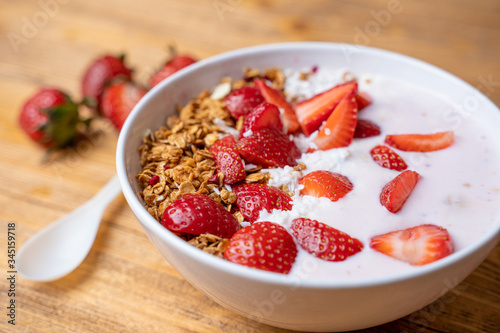 Breakfast with yogurt, granola, with superfood toppings, closeup view. Concept of healthy eating, healthy lifestyle