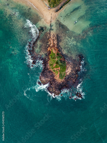 an island in Sri Lanka with a stunning blue ocean. Shot from the sky