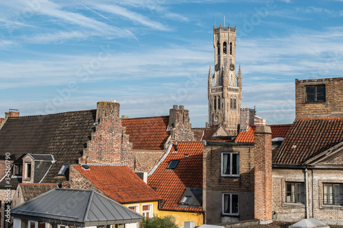 View of the old town of Bruges Belgium.  Belfry tower protrudes above the typical tiled roofs. © Nancy Pauwels