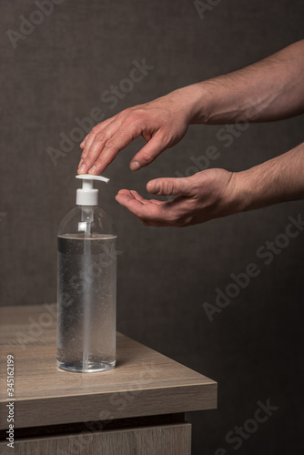 Hand sanitizer alcohol gel rub clean hands hygiene prevention of coronavirus virus outbreak. Man using bottle of antibacterial sanitiser soap. coronavirus, covid 19