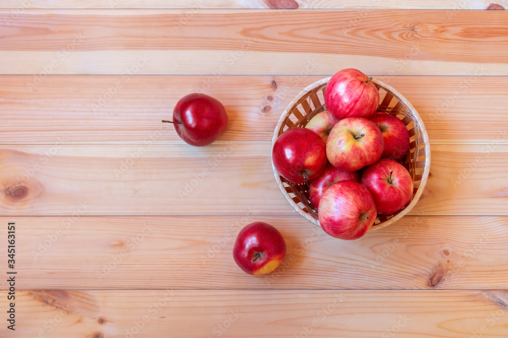 Basket with apples on wooden background. Top view, copy space. Basket with apples on wooden background. Top view, copy space.