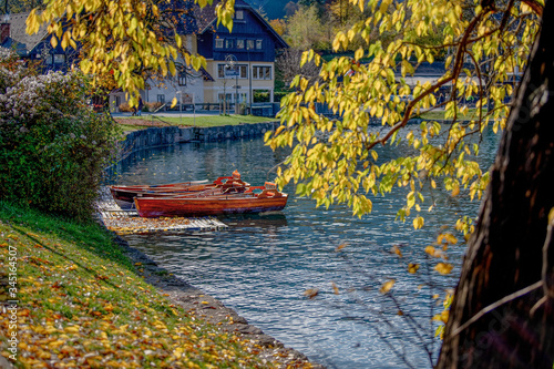 Scenic view on beautiful wooden traditional Pletna boats on the Bled Lake , Slovenia. A boat that transports tourists to the island where the church Assumption of Maria is located.