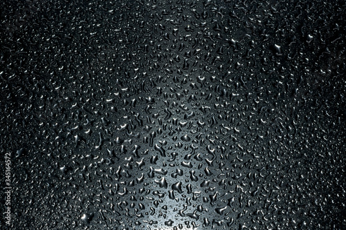 small drops on a dark metal surface.
