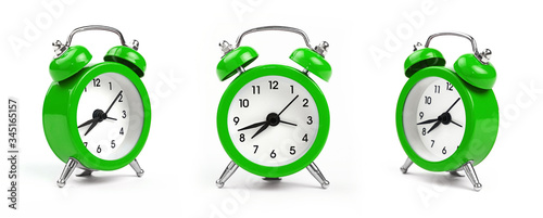 Three green alarm clock over white