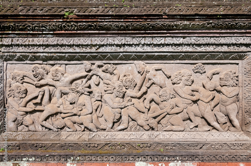 Violent stone wall carving Pura Dalem Penunggekan Temple Bali Indonesia