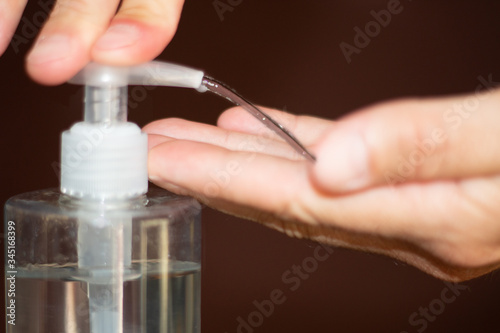 Close-up of a man's hands washing his hands with antiseptic gel
