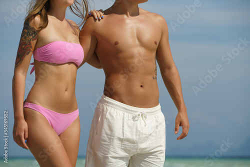 Young happy couple on tropical beach at summer vacation. Thailand