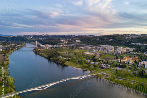 Coimbra drone aerial view of the city park, buildings and bridges at sunset, in Portugal © Luis
