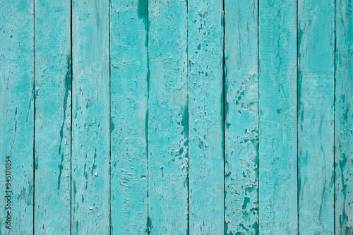 Cracked blue wood background. Timber vertical plank, scratched surface. Turquoise wooden fence background. Copy space. Vintage texture boards.