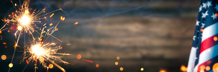 Vintage American Flag With Sparklers And Smoke On Rustic Wooden Background - Independence Day Celebration Concept