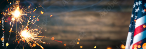 Vintage American Flag With Sparklers And Smoke On Rustic Wooden Background - Independence Day Celebration Concept photo