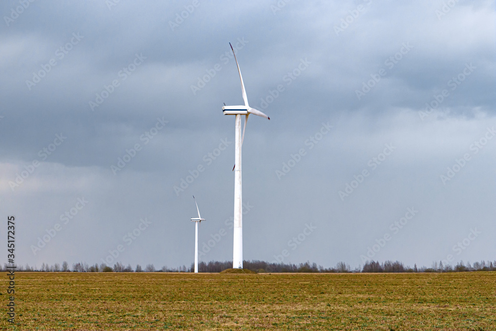 Wind energy concept. Turbines in rural area to supply countryside with electricity Wind energy concept. Turbines in rural area to supply countryside with electricity