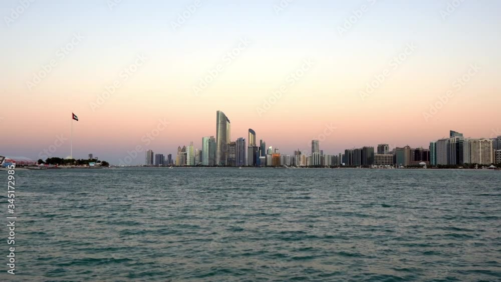 View modern city architecture and skyscrapers - Abu Dhabi skyline and beach at sunset | UAE | Corniche View modern city architecture and skyscrapers - Abu Dhabi skyline and beach at sunset | UAE | Corniche