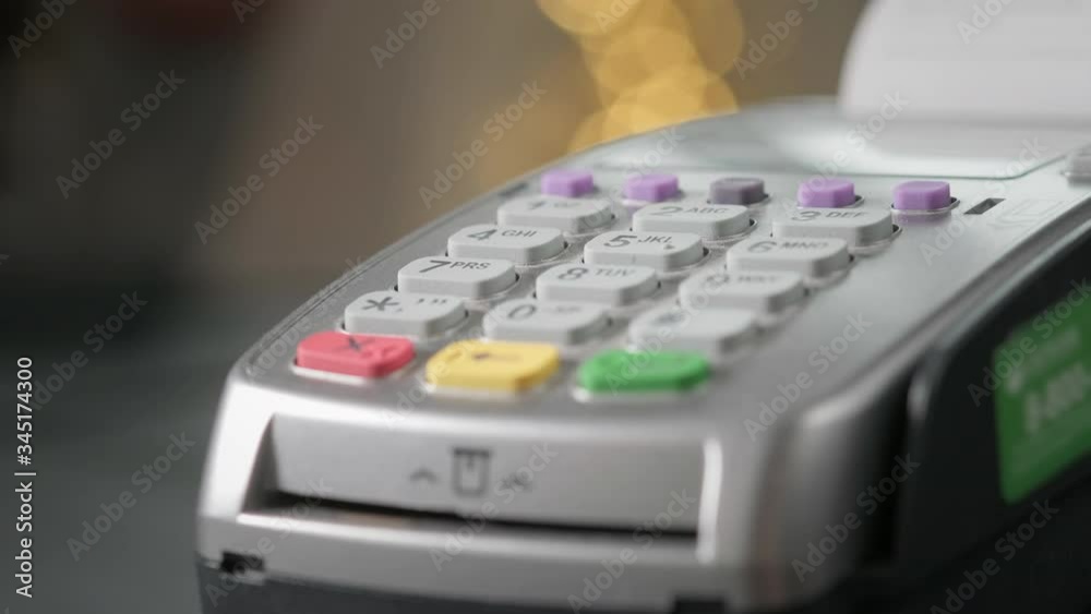 The user makes payment by credit card. Swipe to the terminal of non-cash payment. Man hand with credit card swipe through pos terminal. Banking services of electronic money, making transaction The user makes payment by credit card. Swipe to the terminal of non-cash payment. Man hand with credit card swipe through pos terminal. Banking services of electronic money, making transaction