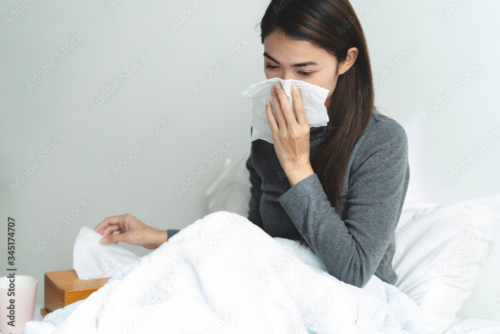 Young asian girl have running nose and sick in the bedroom. Young asian girl have running nose and sick in the bedroom.