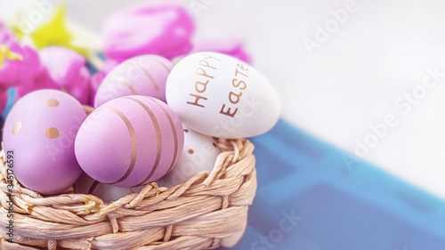 Colorful Easter eggs in a basket on the table. Festive decor for Easter