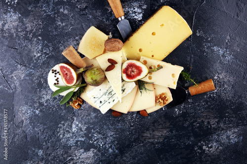 Cheese plate served with figs, various cheese on a rustic table