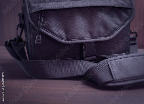 A close-up image shows the photographer's bag where he keeps his camera