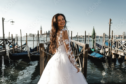 beautiful bride dressed in a wedding dress and stands near the pier,fashionable wedding dress,smiling bride in dress, © Vadym