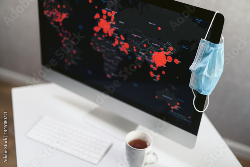 Fotografie Office computer with a map of the spread of coronavirus infection