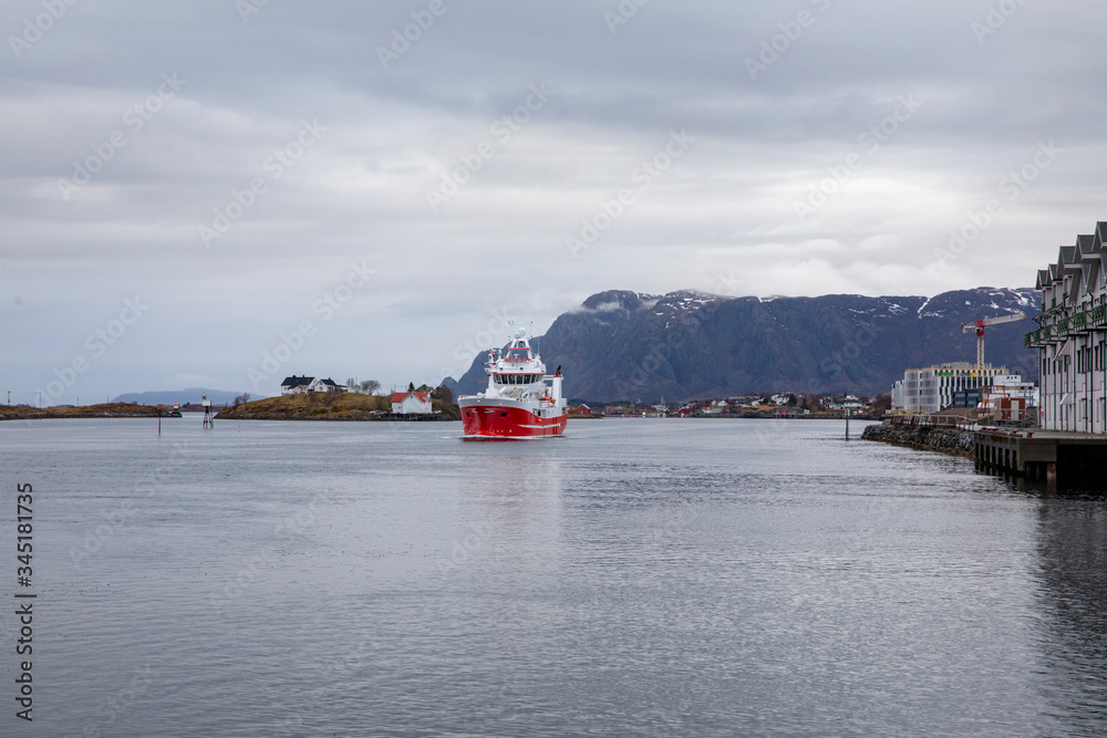 Red fishing boat Trondskjær off Tromsø/ trawler passes through Brønnøysundet in Nordland county