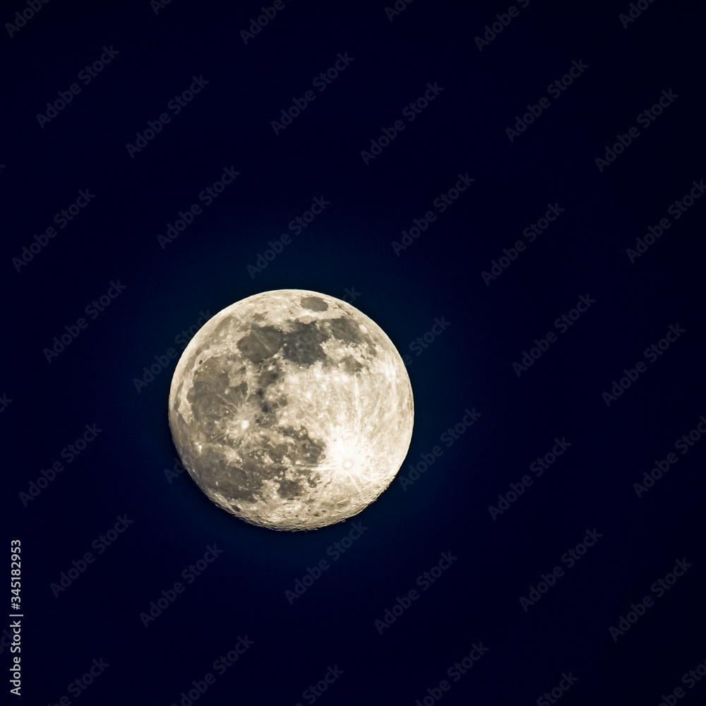 Fototapeta premium A large full moon in a dark sky