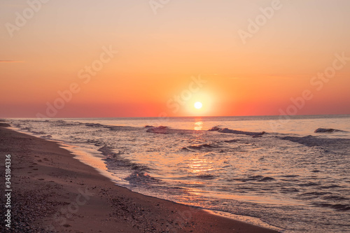 Sea surf, waves, beautiful dawn sunrise at the Black sea, Odessa area, Lebedevka. Seascape.