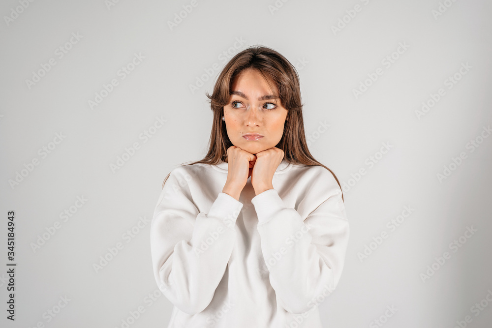 Shocked beautiful woman with hands near the face. Isolated closeup portrait on white background Shocked beautiful woman with hands near the face. Isolated closeup portrait on white background