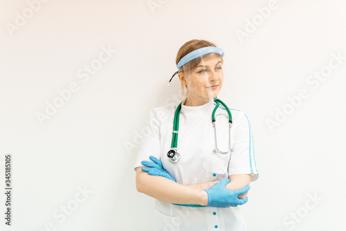 Coronavirus remedy young woman in a protective mask screen with a visor on a white background