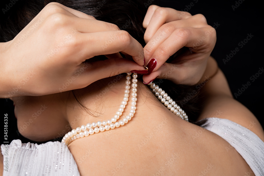 woman wearing pearl diamond necklace