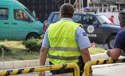 North Kosovska Mitrovica , Kosovo - September 9, 2018: Back view of policeman at center North Kosovska Mitrovica photo