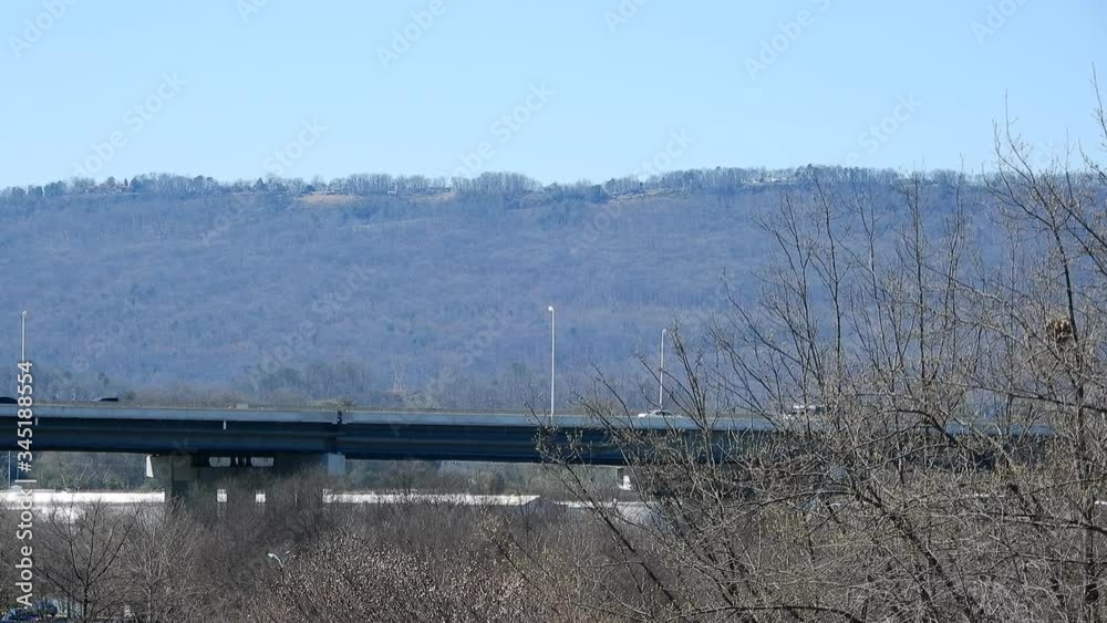 Traffic Driving Over Bridge In Distance With Appalacian Mountains In Background Traffic Driving Over Bridge In Distance With Appalacian Mountains In Background