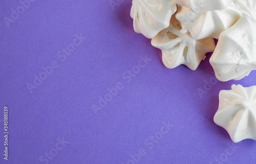 A popular French meringue dessert on a lilac background with copyspace