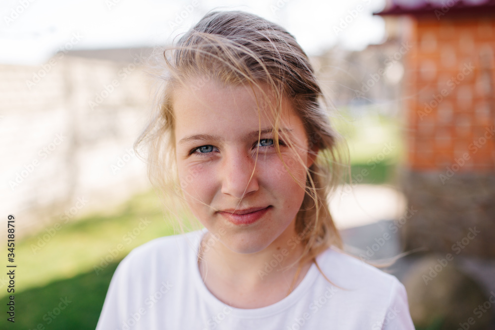 portrait of blue-eyed girl. little blond girl with disheveled hair. serious girl face expression portrait of blue-eyed girl. little blond girl with disheveled hair. serious girl face expression
