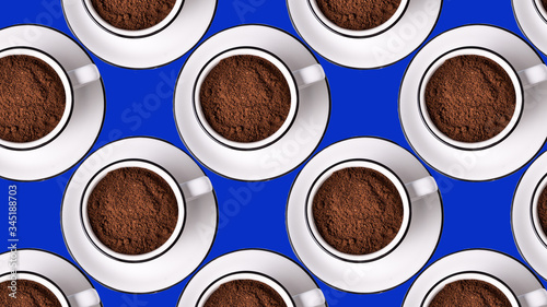 Seamless Pattern made with ground coffee cups on blue background.