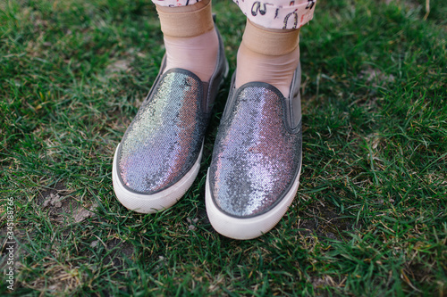 gray women's slippers with sparkles. Slip on feet. shiny shoes © Anhelina Tyshkovets