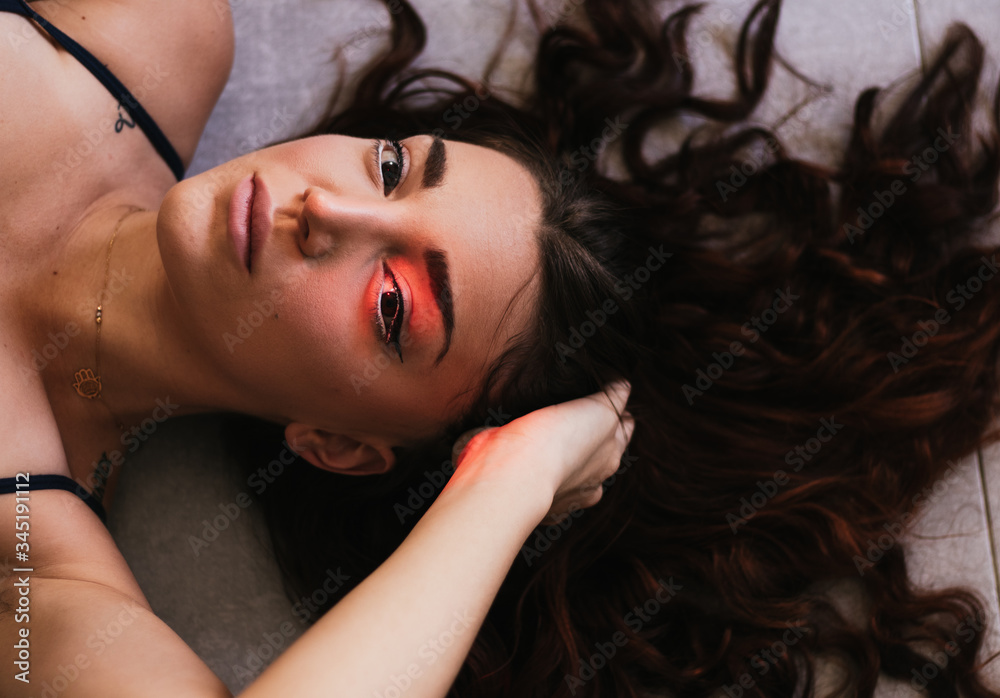 Close up Sensual Woman Lying on the Floor with Long Tousled Hair Close up Sensual Woman Lying on the Floor with Long Tousled Hair