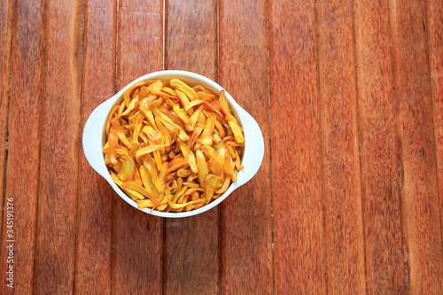 Jack fruit fry in the white bowl isolated on wooden background