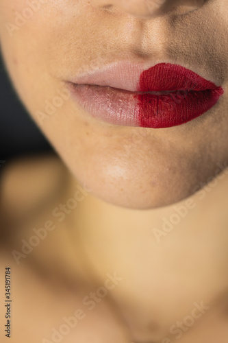 Close up of female lips with two different lipsticks photo
