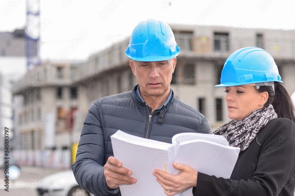 construction manager in discussion with the architect on a building site construction manager in discussion with the architect on a building site