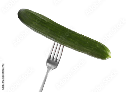 A fresh cucumber on a metal fork isolated on white background © Andriy Medvediuk