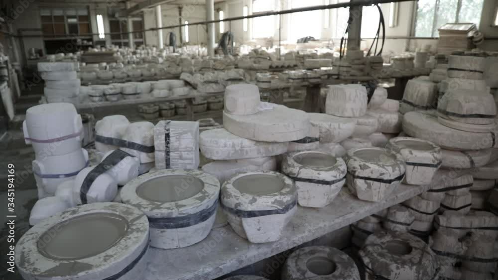 Clay workshop. Wooden shelf. Forms for pouring clay for making dishes. General plan. Panorama. Grayscale.