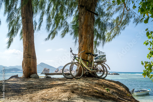 Fototapeta Naklejka Na Ścianę i Meble -  Peaceful tropical seascape with bikes and filao tree
