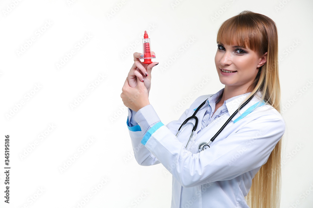 conceptual photo of a pediatric doctor. smiling woman doctor holds a toy syringe isolated on a white background with copy space. conceptual photo of a pediatric doctor. smiling woman doctor holds a toy syringe isolated on a white background with copy space.