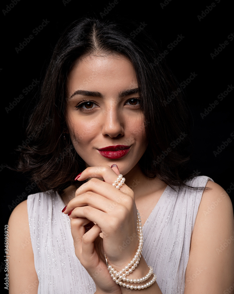 woman with pearl diamond necklace in hand