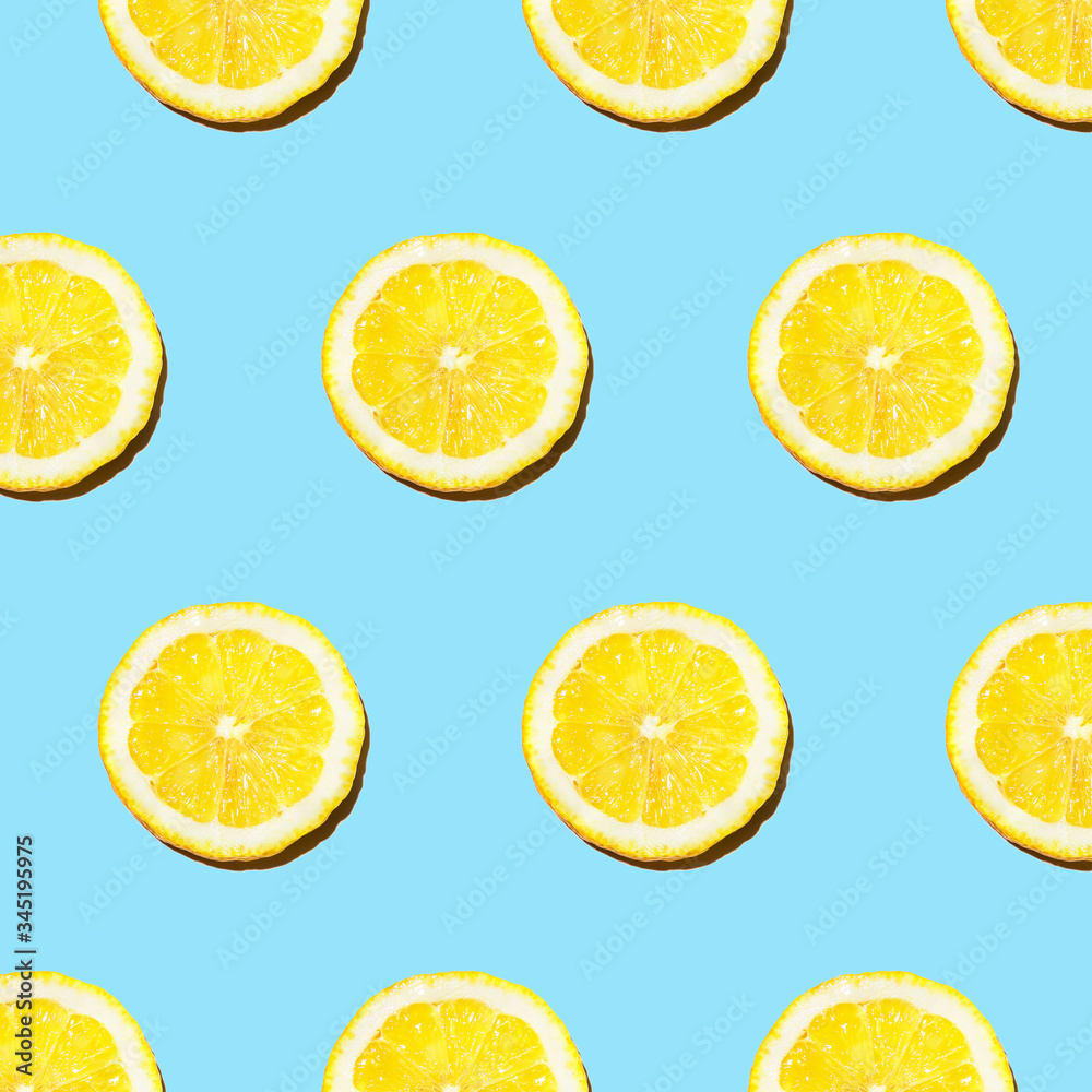 Trendy sunlight Summer pattern made with yellow lemon slice on bright light blue background. summer concept.